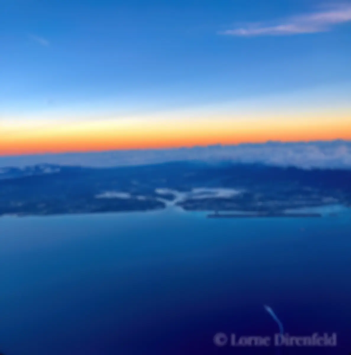 From 10,000 feet, looking to the north and Pearl Harbor, with the reef runway offset from the rest of the island . . ..  . .