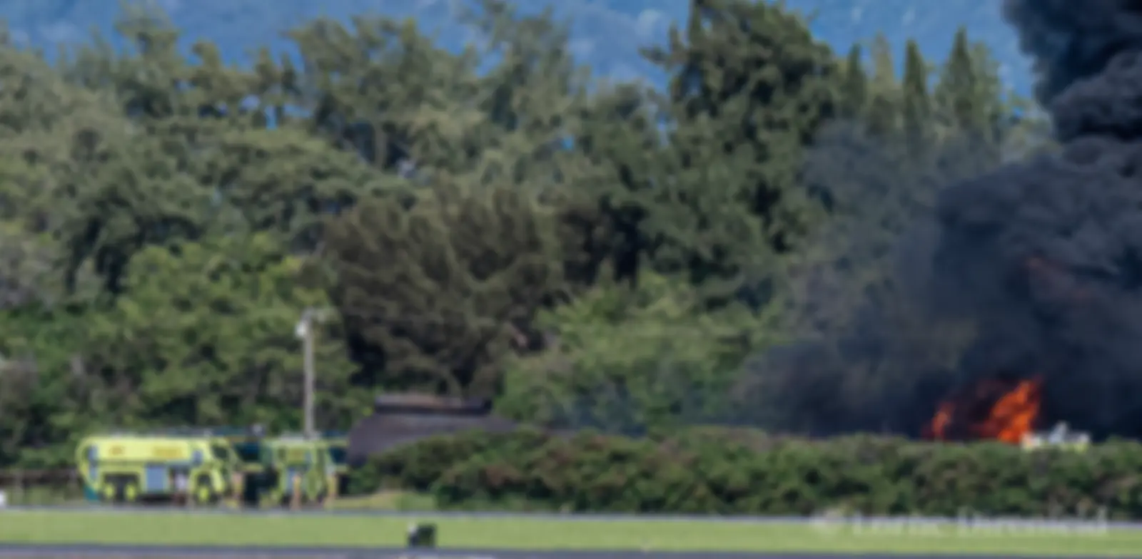 Aircraft rescue and firefighting (ARFF) team practicing extinguishing a fire in a mock airplane fuselage at Kahului airport . . .