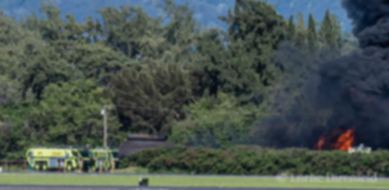 Aircraft rescue and firefighting (ARFF) team practicing extinguishing a fire in a mock airplane fuselage at Kahului airport . . .