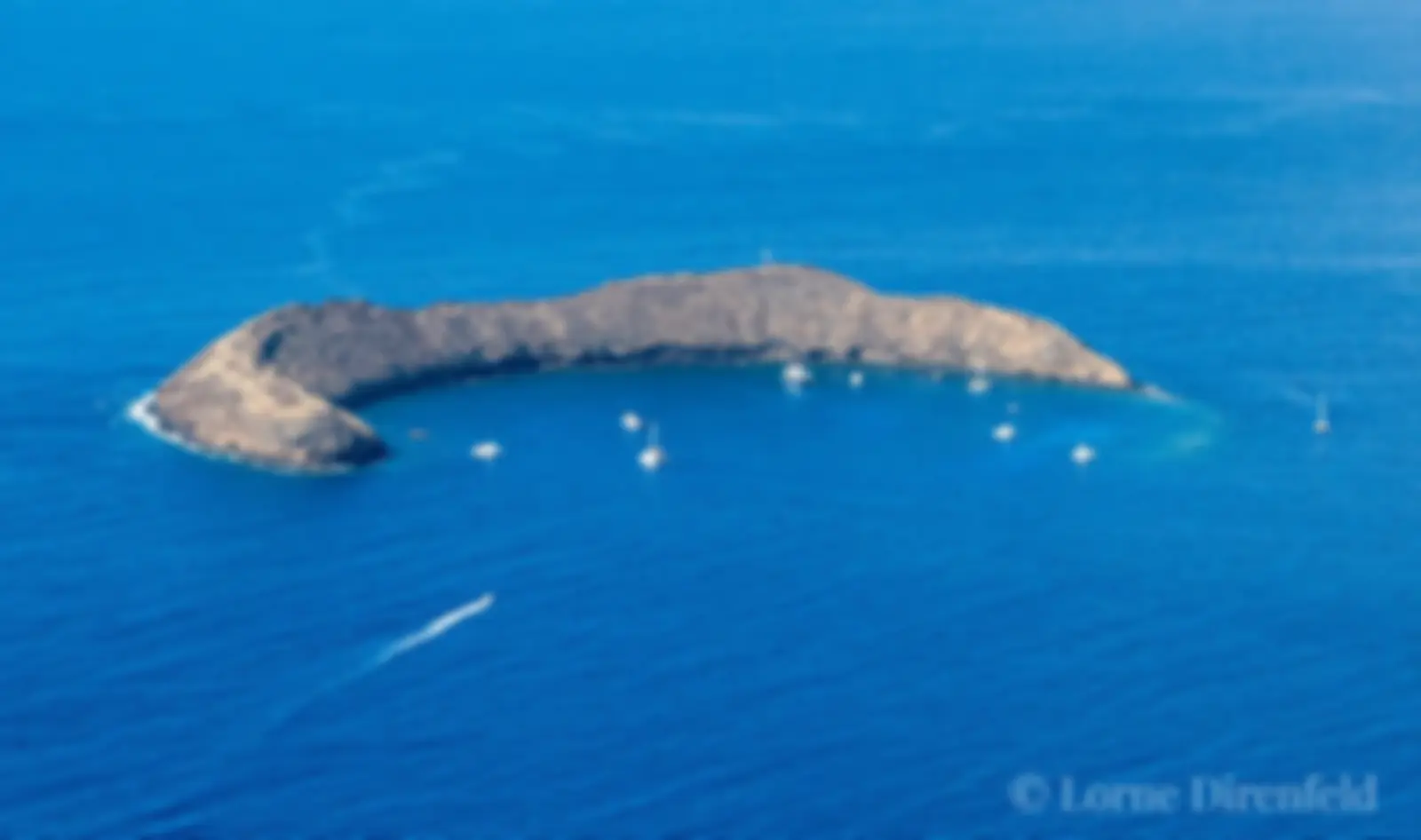 Snorkel tour boats at Molokini crater in the morning . . .