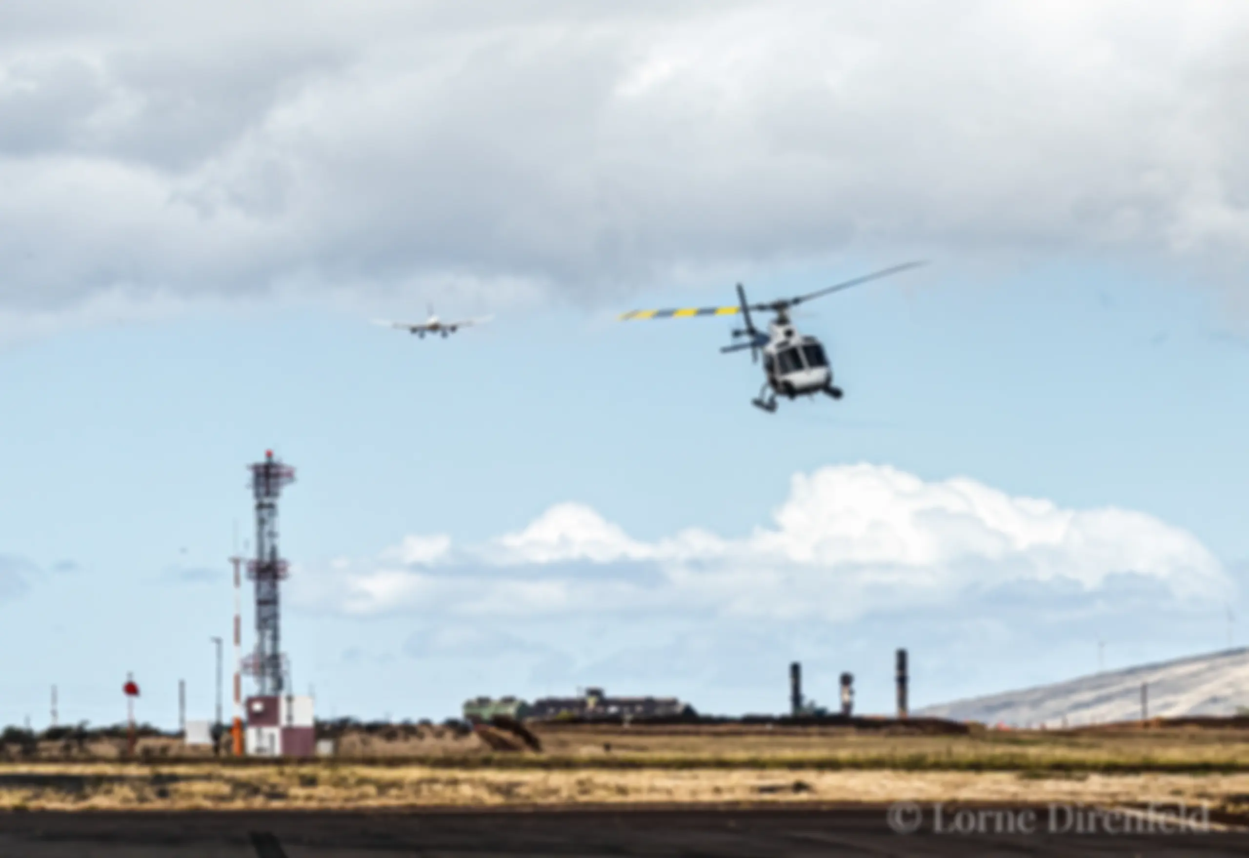 A tour helicopter departs ahead of a B737 on short approach to Runway 2 at Kahului airport . . .