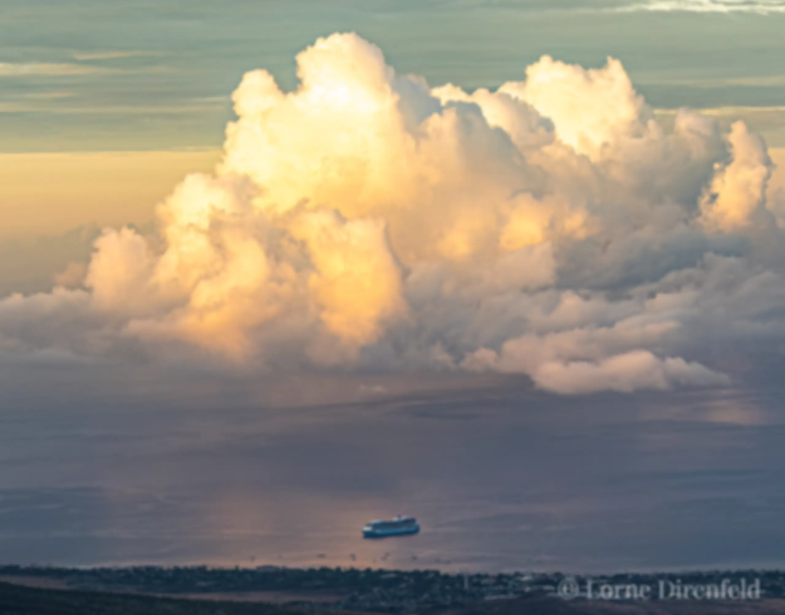 The morning light and puffy clouds dwarf a cruise ship at Lahaina, with Lanai in the background  . . .