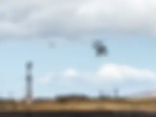 A tour helicopter departs ahead of a B737 on short approach to Runway 2 at Kahului airport . . .