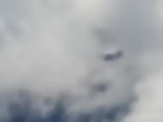 A Cessna 208 Caravan passing below, at 10 moving to 9 o'clock . . .