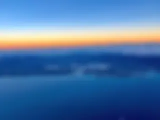 From 10,000 feet, looking to the north and Pearl Harbor, with the reef runway offset from the rest of the island . . ..  . .