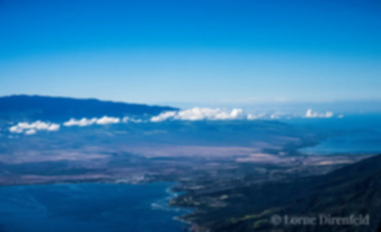 Looking across the central valley towards Haleakala, from a perch in the sky above west Maui in the morning; the peak of Mauna Kea is seen faintly in the distance . . .