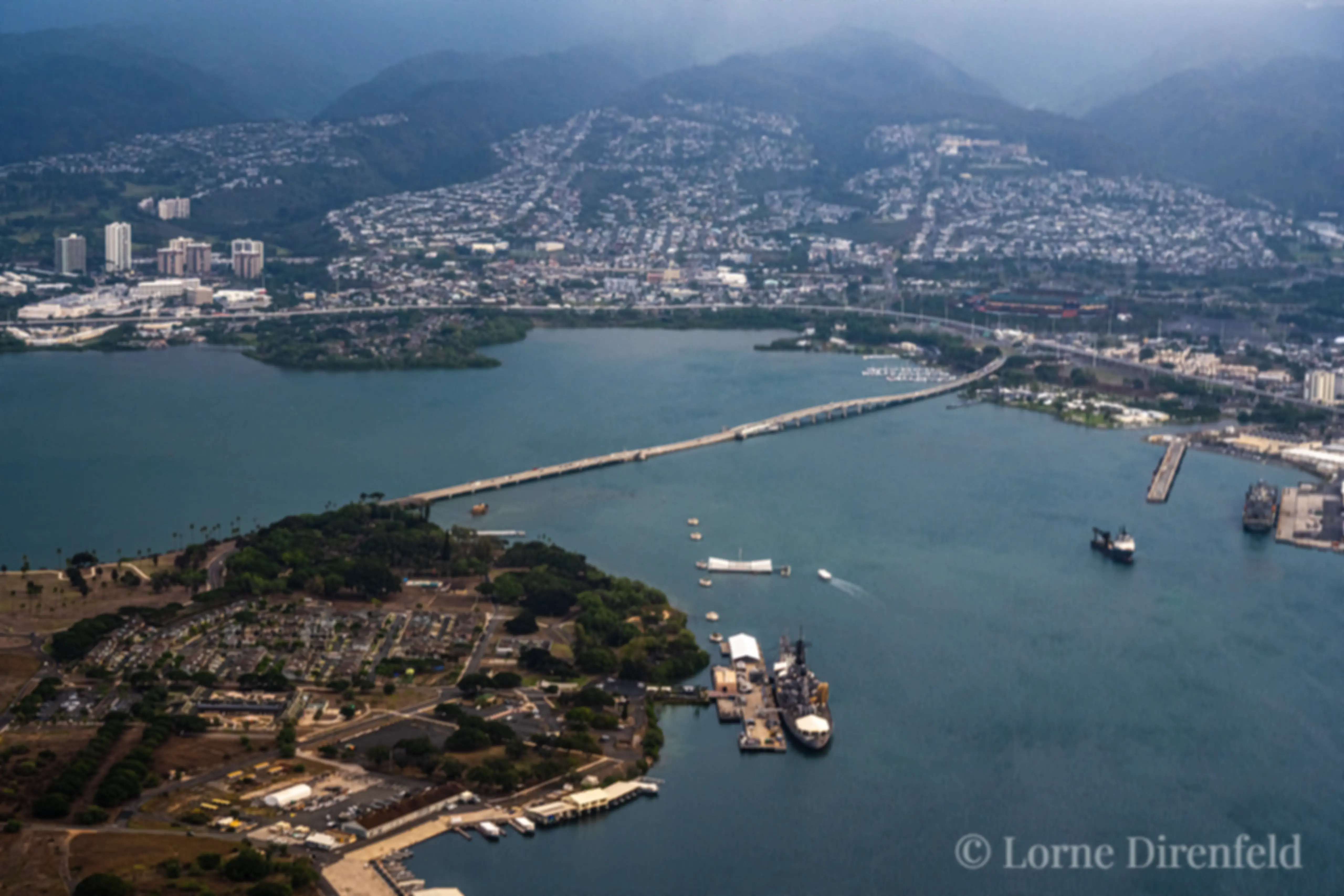 The bridge connects Ford island in Pearl Harbor to the mainland of Oahu . . . The Arizona Memorial can be seen just below the center of the image . . . The battleship Missouri is near the center lower part of the image . . .