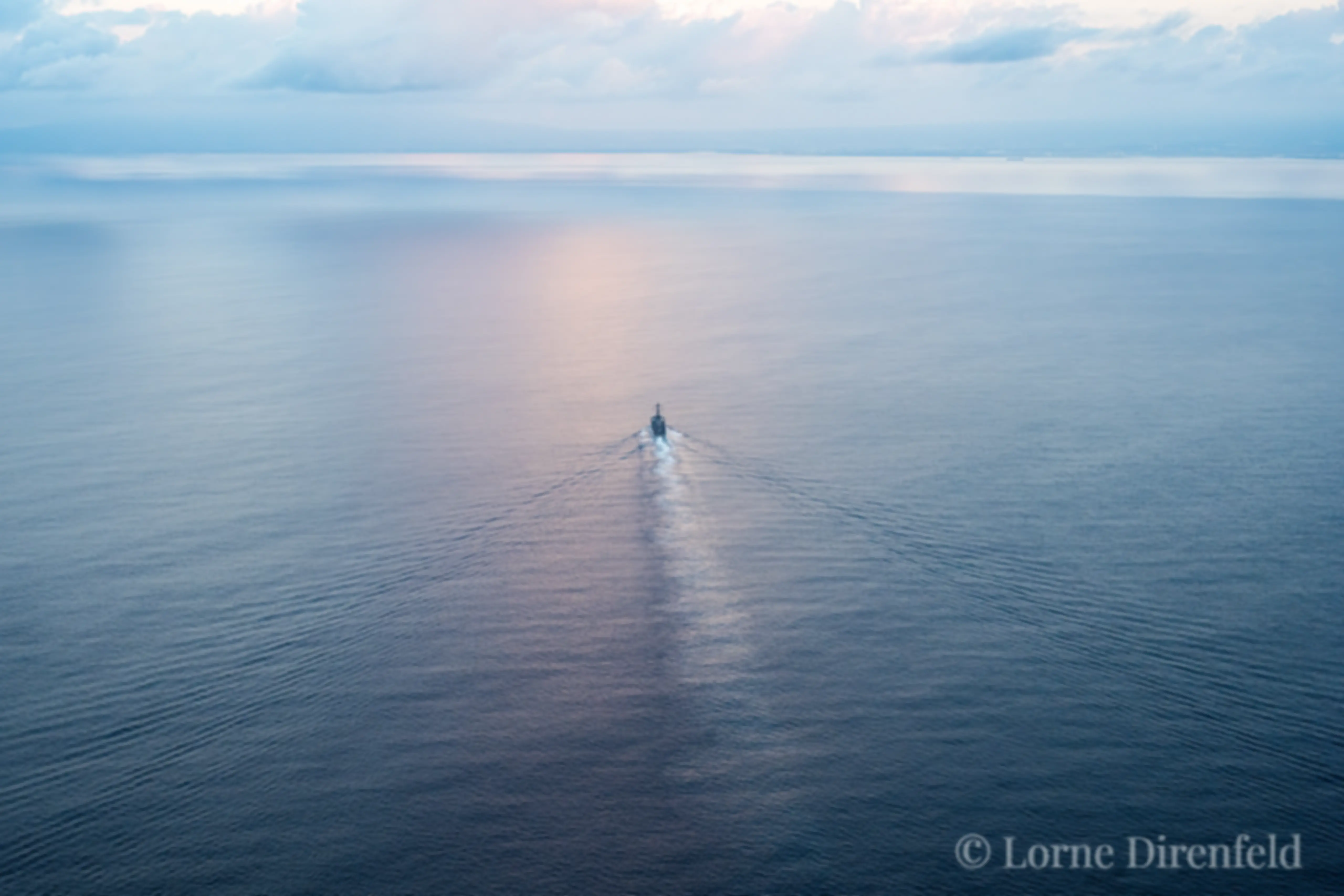 A navy ship sails from Pearl Harbor in the early morning . . .