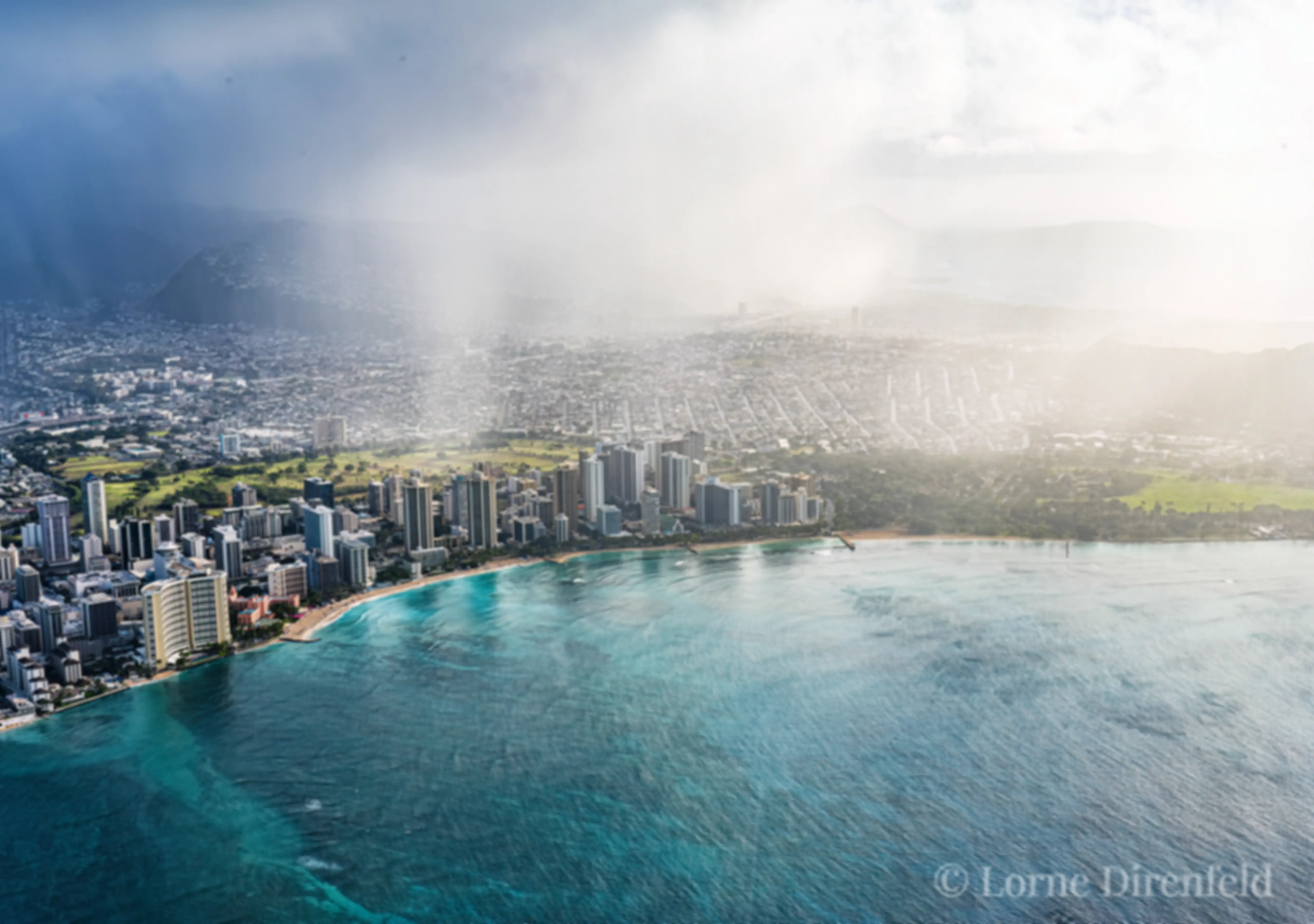 A morning shower on land, with clear skies and blue water off shore . . .