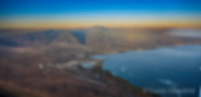 From about 8,000 feet, early morning, looking toward Kahului harbor and west Maui, with Molokai in the background . . .