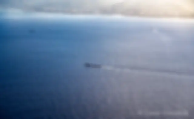 A submarine returns to Pearl Harbor . . .