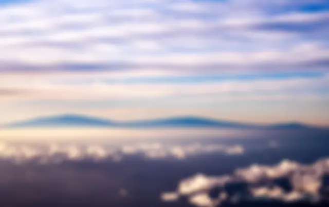 Mauna Kea, Mauna Loa and Hualalai mountains on the Big Island of Hawaii in the early morning . . .