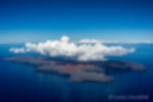 Kaho'olawe in the late morning, with a cover of convective clouds, as seen from about 5000 feet, from the northeast. This photo has been selected for the permanent archives of the State of Hawaii . . .