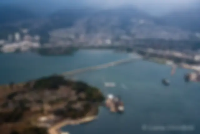 The bridge connects Ford island in Pearl Harbor to the mainland of Oahu . . . The Arizona Memorial can be seen just below the center of the image . . . The battleship Missouri is near the center lower part of the image . . .