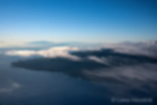 East Maui is in the foreground and the north end of the Big Island is in the distance as seen from 9,000 feet in the early morning . . .